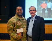 U.S. Air Force Capt. Darryl Scarver, left, 35th Fighter Wing commander’s action group director, poses with retired Col. Leon Ellis, former Vietnam War pilot and prisoner of war, after a presentation at Misawa Air Base, Japan, Nov. 15, 2024.