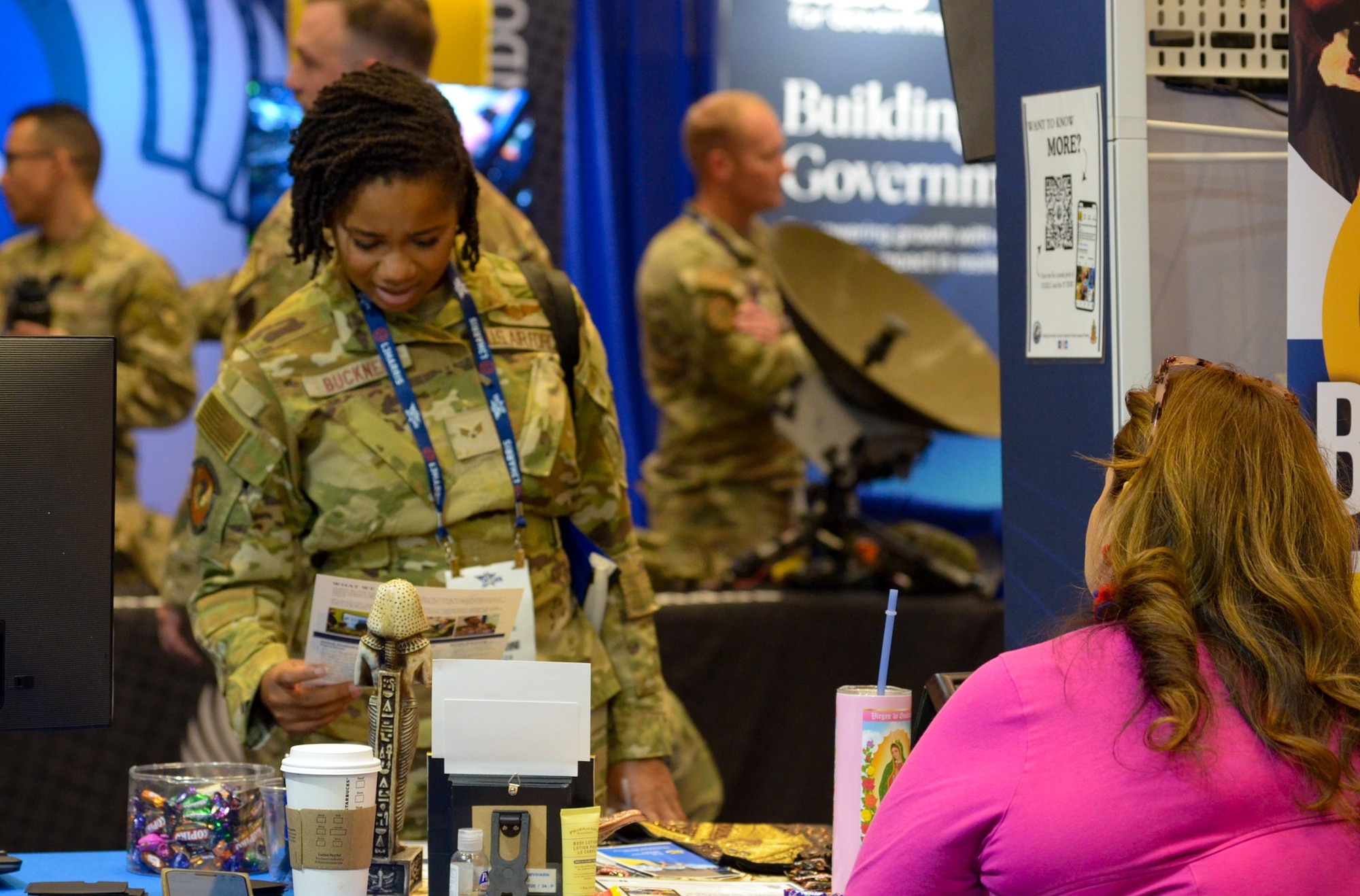Air Force member looks at informational booth.