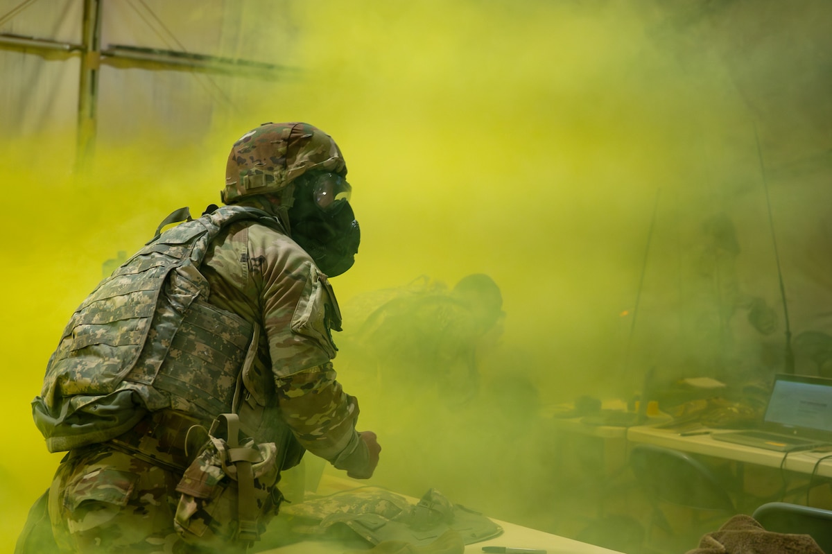 A U.S. Airman assigned to the 11th Air Task Force evacuates the wing operations center after a simulated chemical attack at McGregor Range, New Mexico, Nov. 9, 2024. Airmen donned gas masks and grabbed necessary equipment before relocating to a safe location. (U.S. Air Force photo by Airman 1st Class Jasmyne Bridgers-Matos)