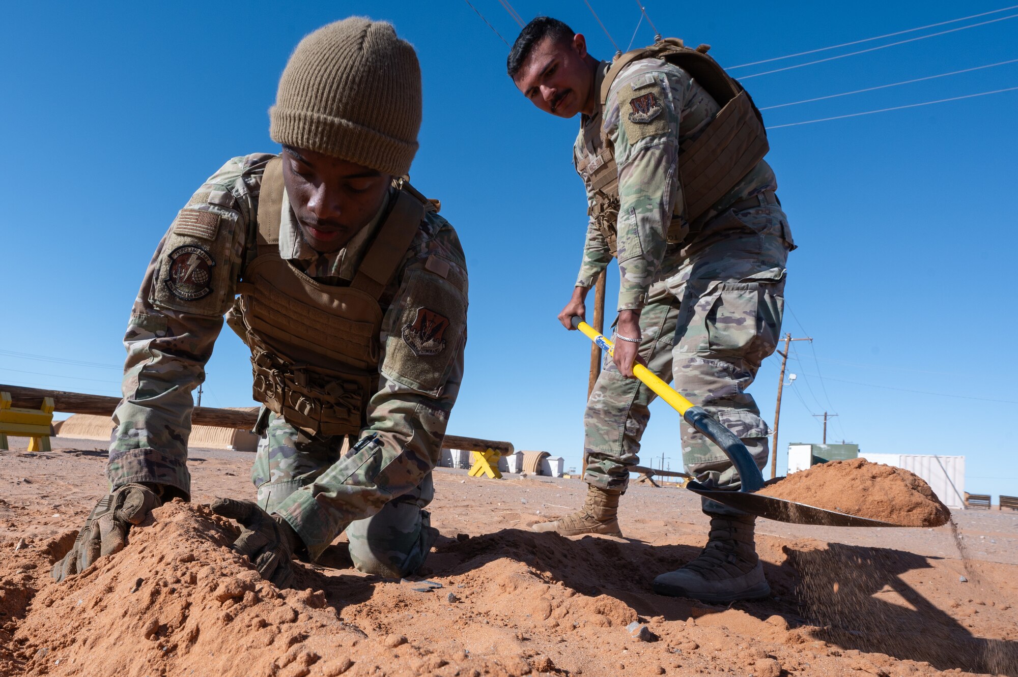 U.S. Airmen assigned to the 11th Air Task Force construct a defensive fighting position during the 11th ATF’s first field exercise at McGregor Range, New Mexico, Nov. 10, 2024. Security forces Airmen taught wingmen how to dig and create a location in the ground from which to provide cover. (U.S. Air Force photo by Airman 1st Class Jasmyne Bridgers-Matos)