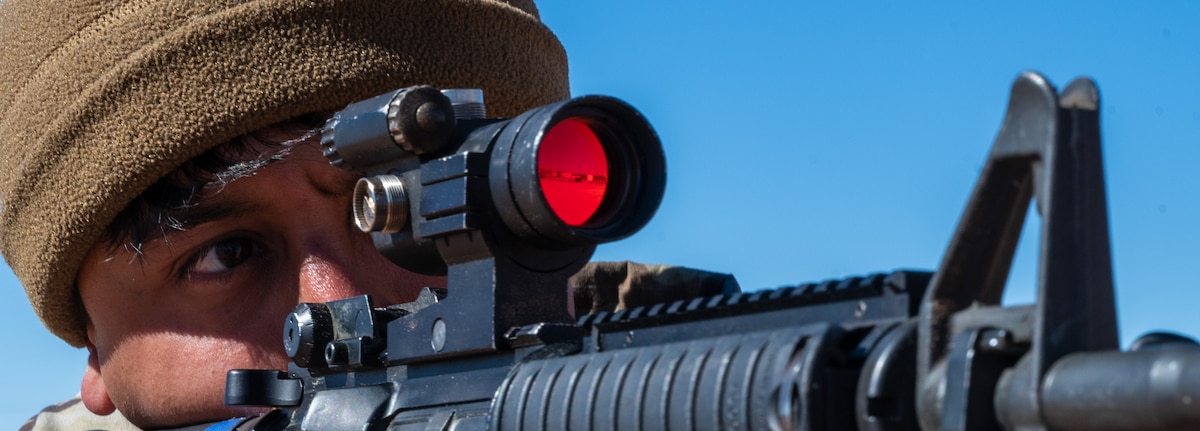 U.S. Air Force Senior Airman Jhony Rivera, 355th Civil Engineer Squadron hvac journeyman, looks down the scope of an M4 carbine during the 11th Air Task Force’s first field exercise at McGregor Range, New Mexico, Nov. 10, 2024. Security forces Airmen conducted weapons familiarization training for fellow 11th ATF members to ensure mission success. (U.S. Air Force photo by Airman 1st Class Jasmyne Bridgers-Matos)