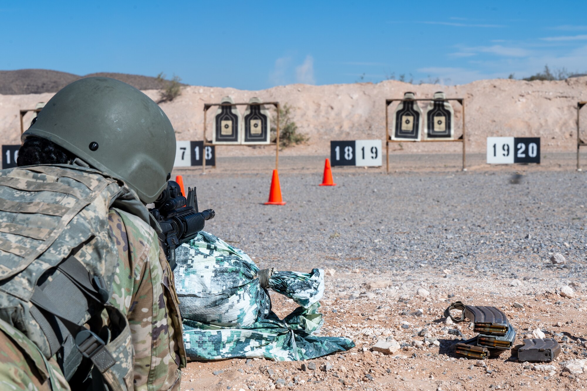 U.S. Air Force Senior Airman Elisa Strickland, 355th Communications Squadron radio frequency transmission systems technician, fires an M4 carbine at McGregor Range, New Mexico, Nov. 12, 2024. Airmen gained experience using various shooting stances and tactics. (U.S. Air Force photo by Airman 1st Class Jasmyne Bridgers-Matos)