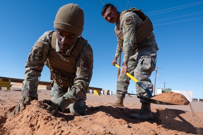 U.S. Airmen assigned to the 11th Air Task Force construct a defensive fighting position during the 11th ATF’s first field exercise at McGregor Range, New Mexico, Nov. 10, 2024. Security forces Airmen taught wingmen how to dig and create a location in the ground from which to provide cover. (U.S. Air Force photo by Airman 1st Class Jasmyne Bridgers-Matos)
