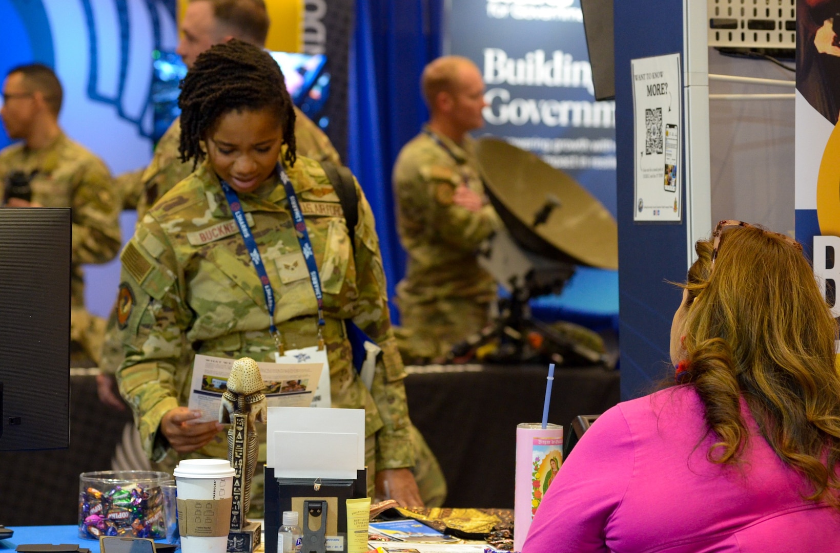 Air Force member looks at informational booth.
