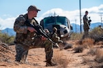 A U.S. Airman assigned to the 11th Air Task Force guards his team while they recover assets from a simulated downed helicopter at McGregor Range, New Mexico, Nov. 8, 2024. Airmen demonstrated their proficiency in using tactical movement and strategies to complete the mission. (U.S. Air Force photo by Airman 1st Class Jasmyne Bridgers-Matos)
