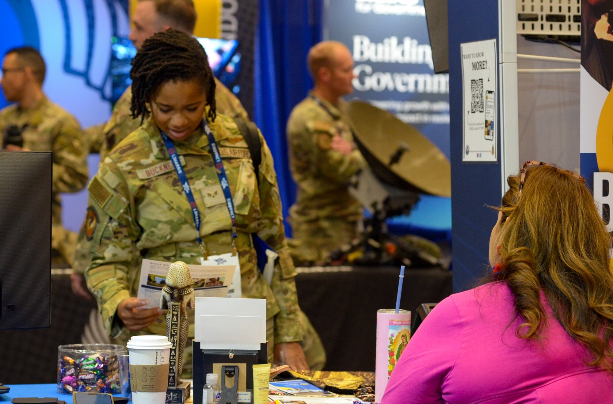 Air Force member looks at informational booth.