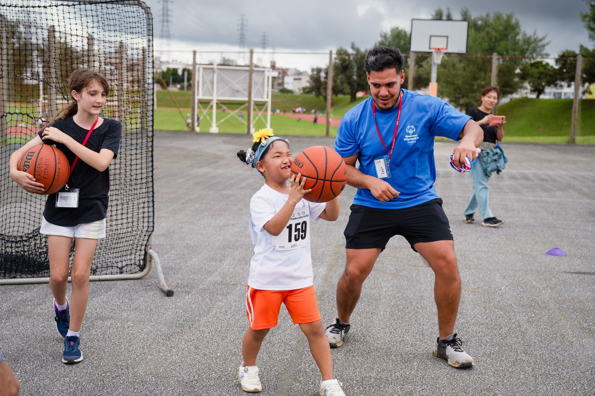 Special Olympic participant and volunteer prepare to shoot basketball