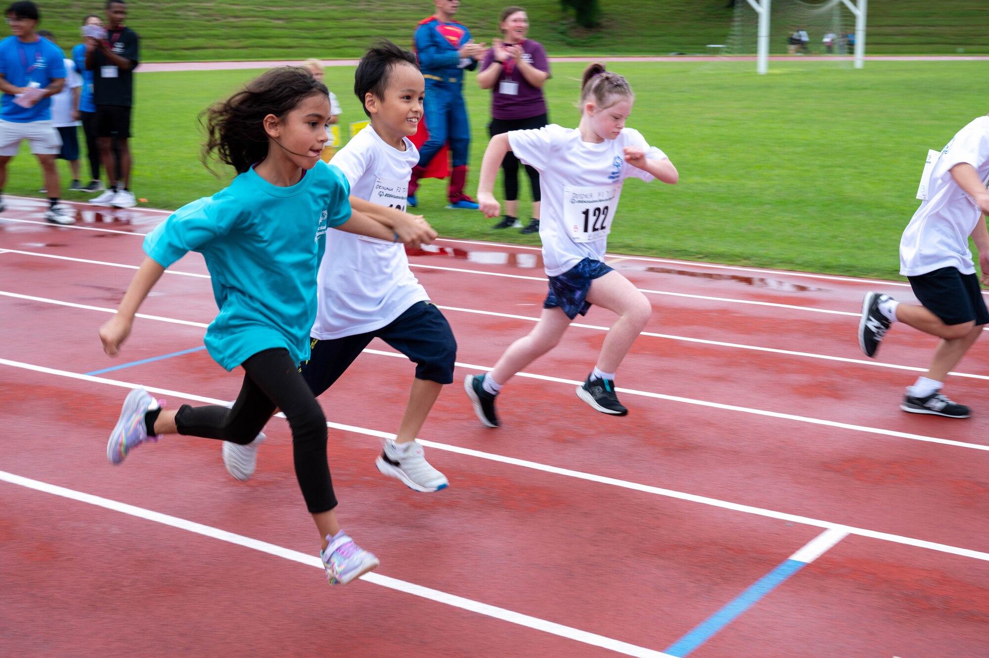 Participants run on the track