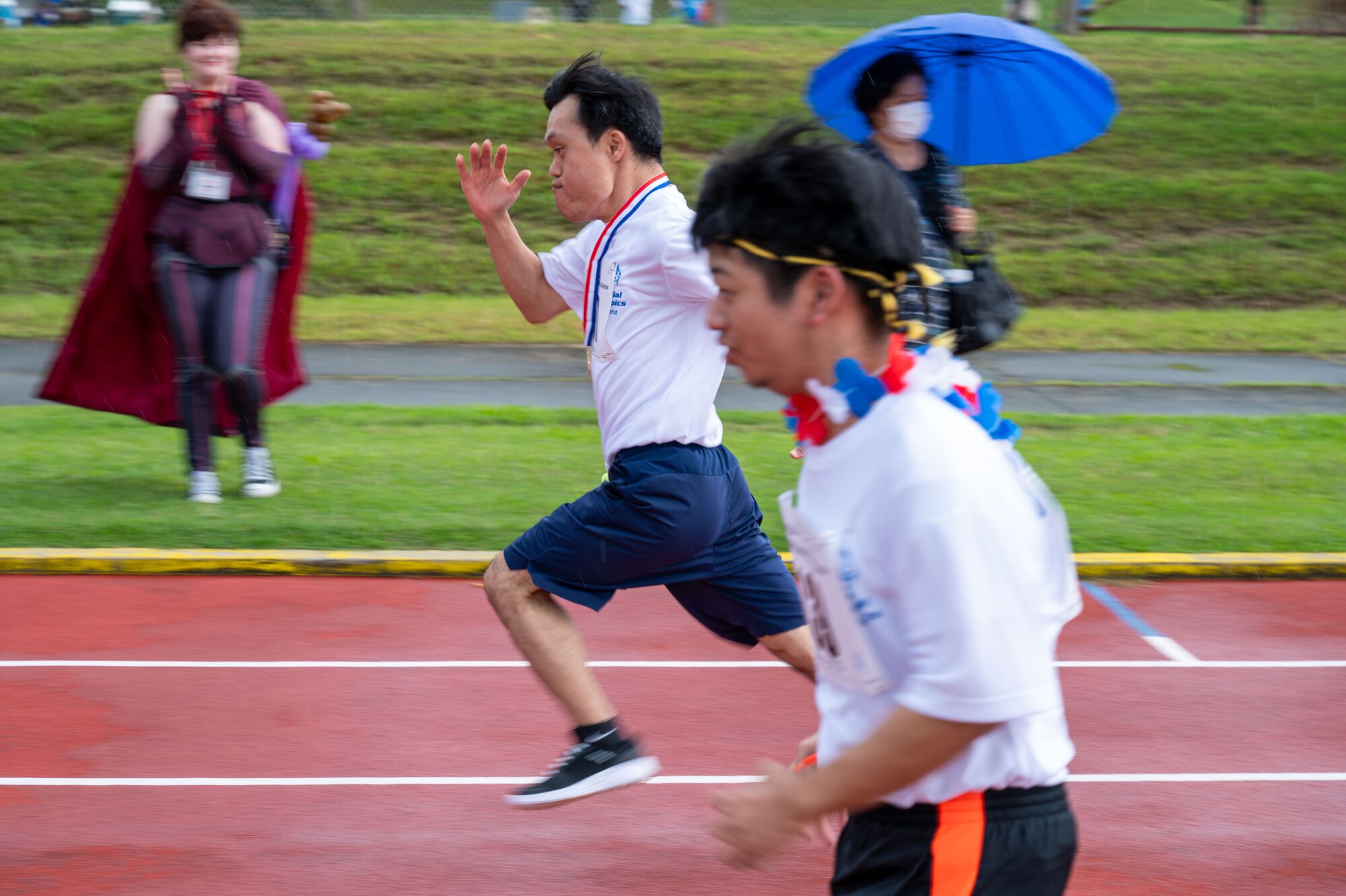 Participants run on a track for a race