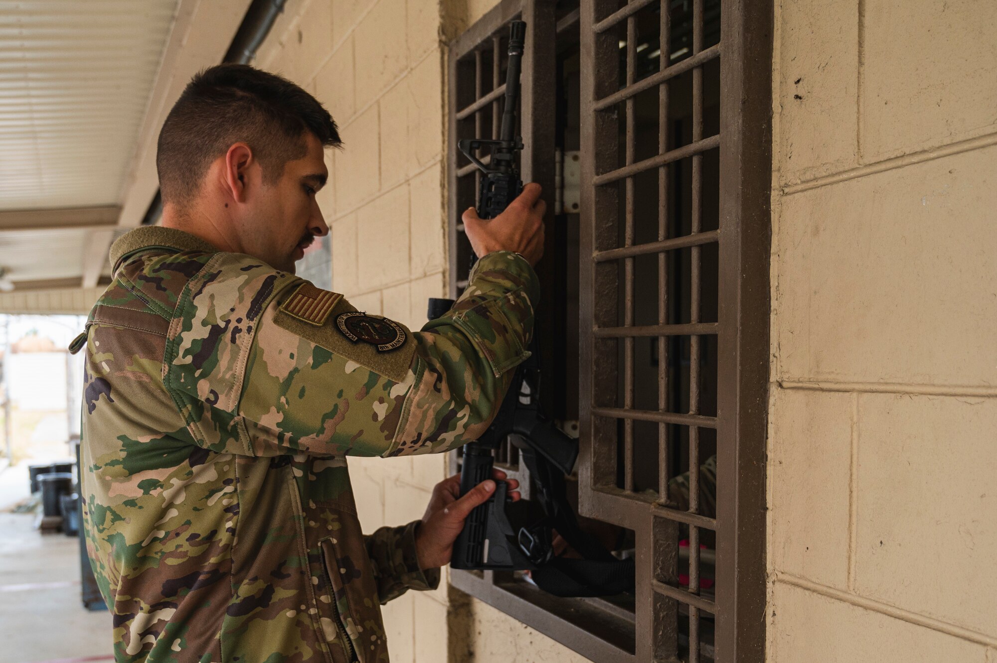 Tech. Sgt. Benjamin Roberds, 8th Maintenance Squadron egress section chief, receives an M-4 rifle as part of general arming during Beverly Sentinel 25-1 at Kunsan Air Base, Republic of Korea.
