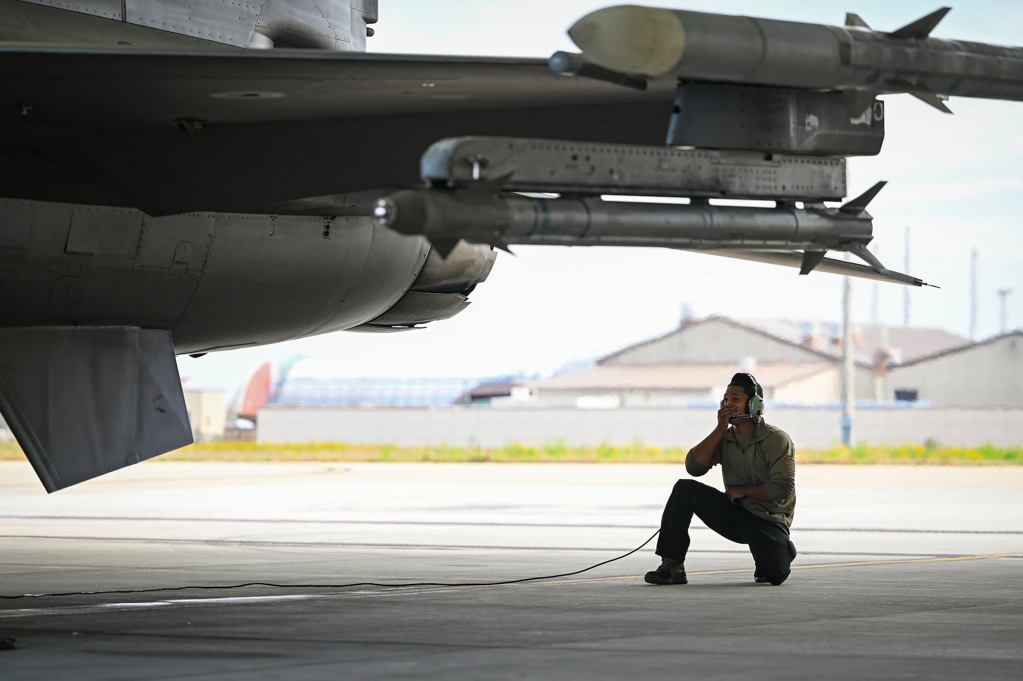 Senior Airman Xavear Cullors, Cobra F-16 Fighting Falcon crew chief, prepares an F-16 aircraft to taxi during Beverly Sentinel 25-1 at Kunsan Air Base, Republic of Korea.