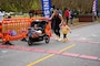 A mom with her children crosses the finish line. NSA Hampton Roads host the Wounded Warrior 5K in support of Wounded Warrior Care month. This is the 10th annual Wounded Warrior 5K. (Photo by Ninoshka Basantes, NSA Hampton Roads Public Affairs Officer.)