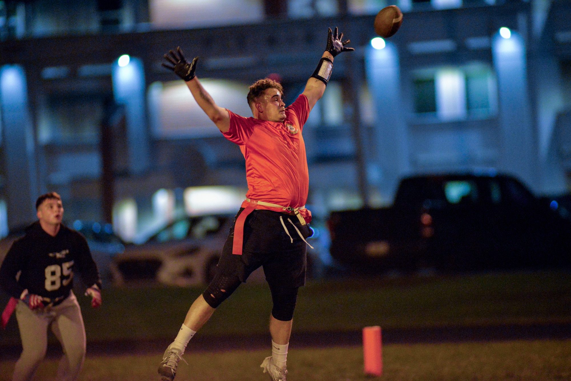 Senior Airman Jermel Allende intercepts a pass during a flag football game.