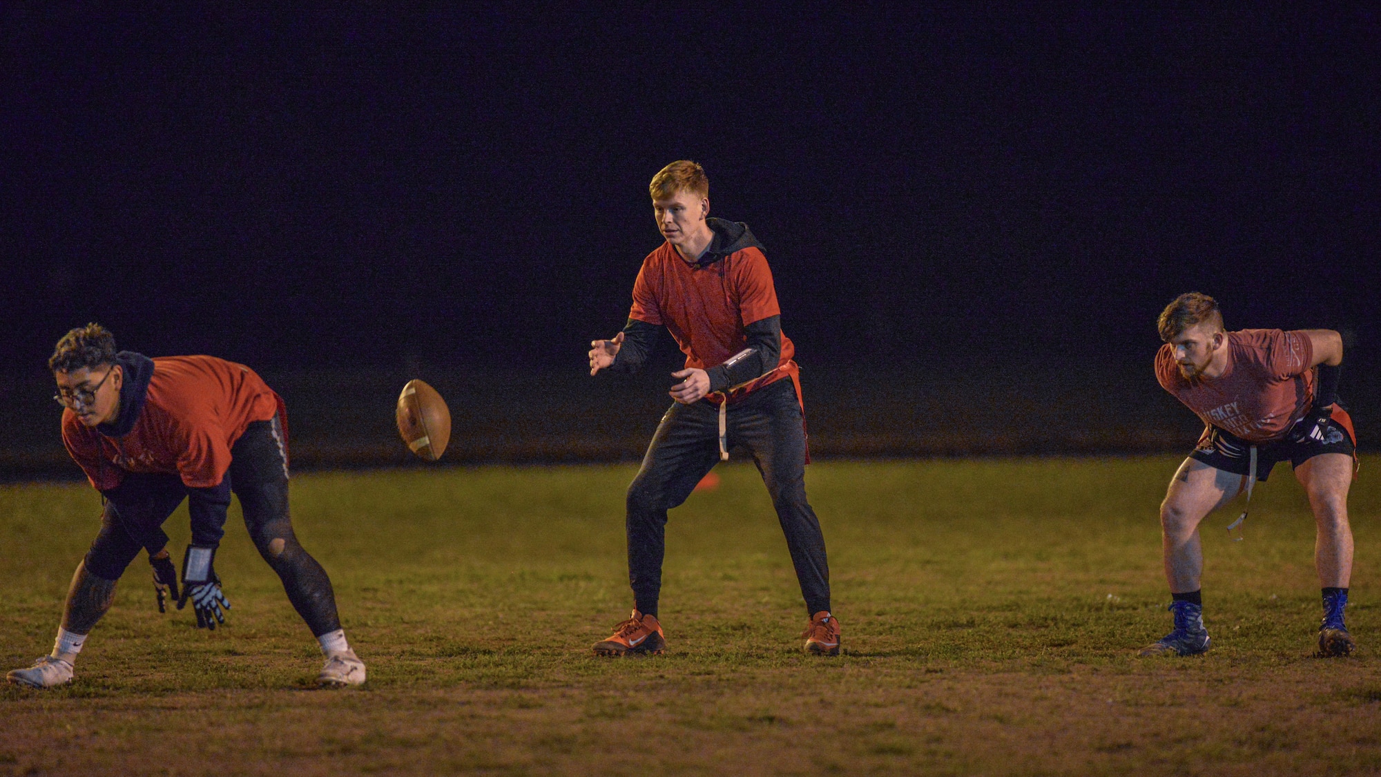 National Air and Space Intelligence Center members start a play  during a flag football game.