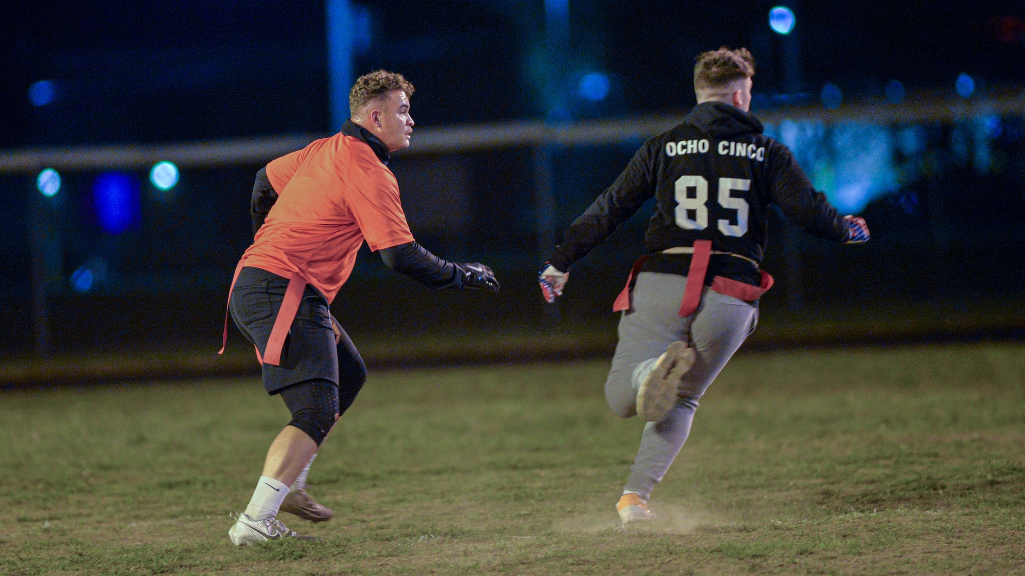 Senior Airman Jermel Allende  assumes a defensive stance during a flag football game.
