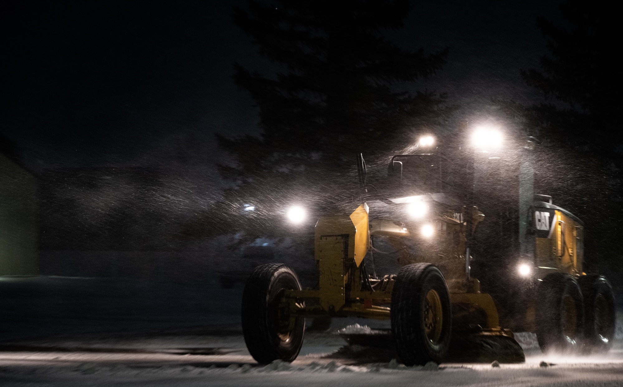 An Airman assigned to the 5th Civil Engineer Squadron (5 CES) plows snow during a storm at Minot Air Force Base, North Dakota, Nov. 19, 2024. Snow removal is one of the most important duties handled by 5 CES, as it is essential to the mission that personnel and aircraft have clear roads and runways. (U.S. Air Force photo by Airman 1st Class Alyssa Bankston)