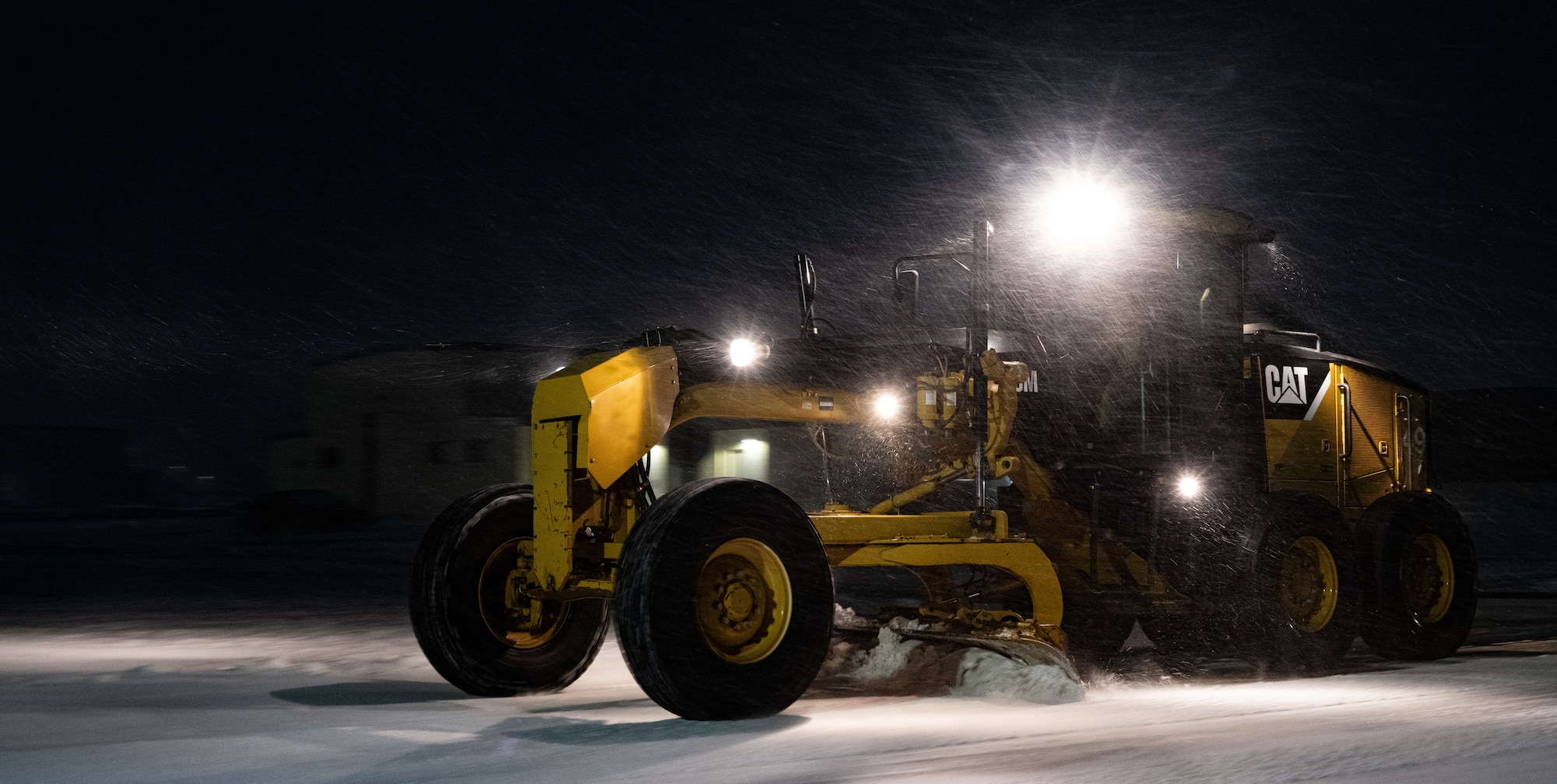 An Airman assigned to the 5th Civil Engineer Squadron (5 CES) plows snow during a storm at Minot Air Force Base, North Dakota, Nov. 19, 2024. Snow removal is one of the most important duties handled by 5 CES, as it is essential to the mission that personnel and aircraft have clear roads and runways. (U.S. Air Force photo by Airman 1st Class Alyssa Bankston)