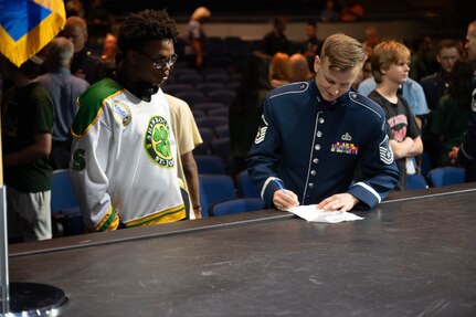 U.S. Air Force Master Sgt. Kristian Baarsvik, alto saxophonist with the USAF Band, signs an autograph for a high school jazz band student after a performance in the Airmen of Note Fall 2024 tour in Tampa, Fla., Nov. 11, 2024. The Airmen of Note’s mission, as a part of the U.S. Air Force Band, is to honor those who have served, inspire American citizens to heighten patriotism and service, and to connect the global community on behalf of the U.S. Air Force and the United States. The Airmen of Note consists of 17 active duty musicians and one vocalist stationed at Joint Base Anacostia-Bolling, Washington, D.C. (U.S. Air Force photo by Hayden Hallman)
