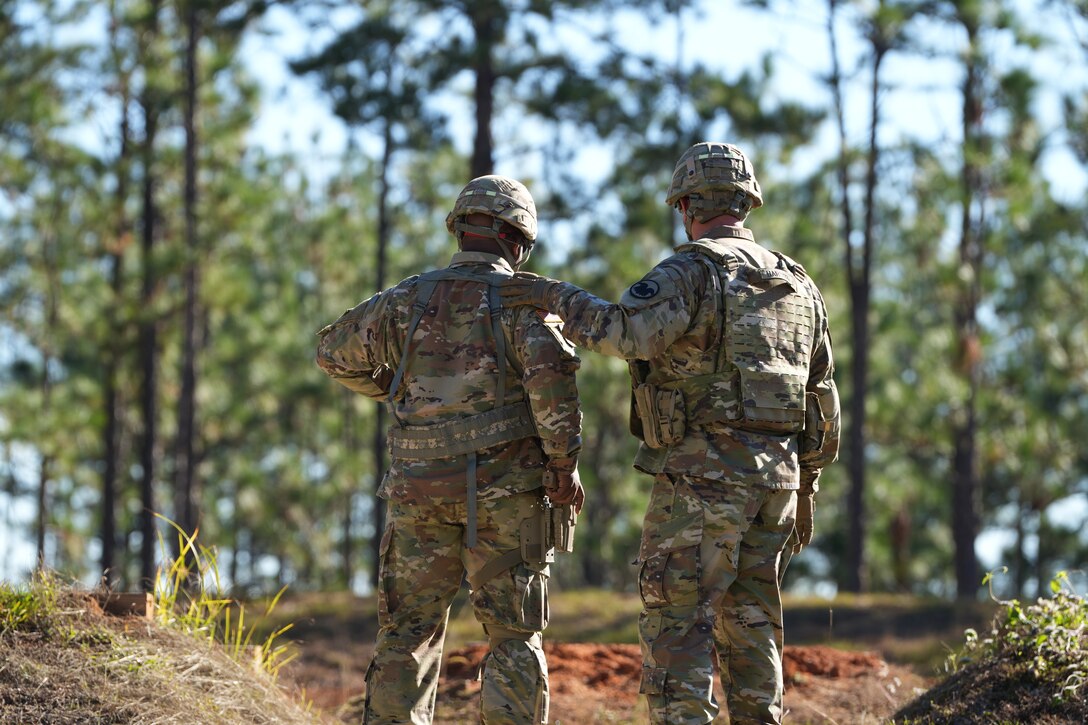 Lt. Gen. Robert Harter, the 35th Chief of the Army Reserve, stands alongside a Soldier from the 412th Theater Engineer Command as they prepare for a qualification shoot with the SIG SAUER M17 P320 at Camp Shelby.