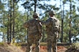 Lt. Gen. Robert Harter, the 35th Chief of the Army Reserve, stands alongside a Soldier from the 412th Theater Engineer Command as they prepare for a qualification shoot with the SIG SAUER M17 P320 at Camp Shelby.