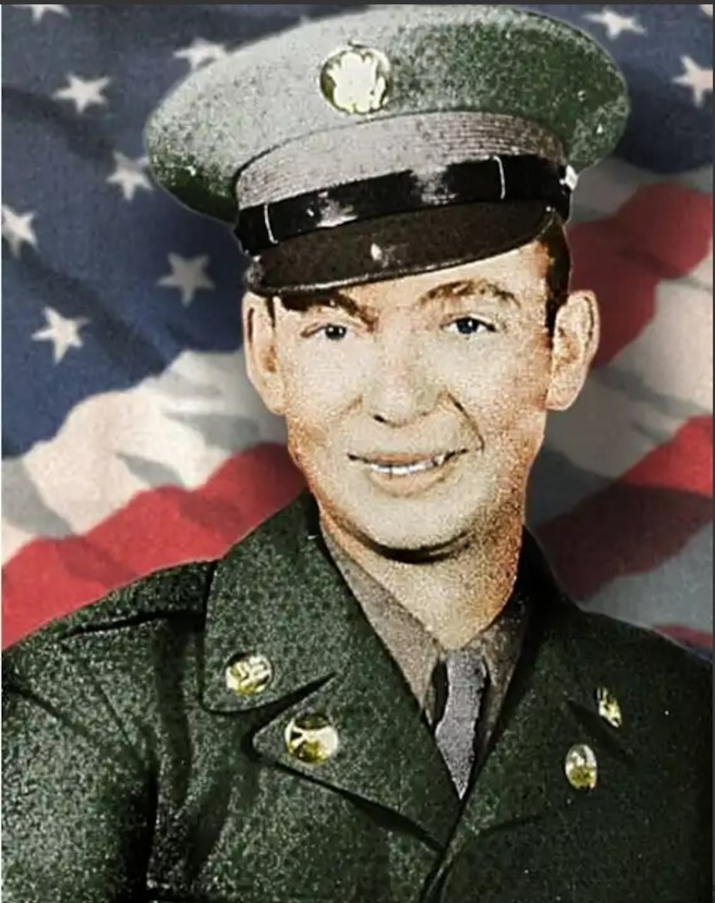 A man in uniform poses for a photo in front of an American flag.