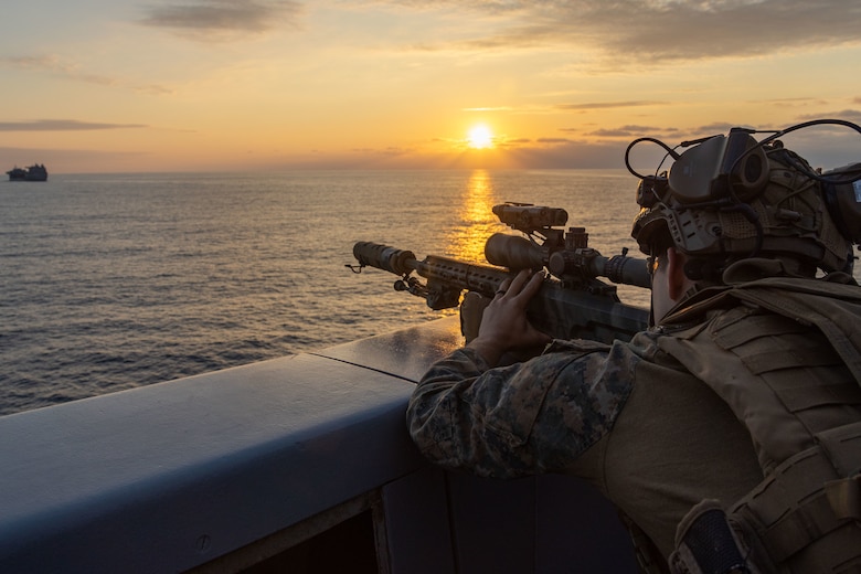 scout sniper with Battalion Landing Team 1/1, 31st Marine Expeditionary Unit, observes the USS Miguel Keith (ESB 5) with a MK22 ASR