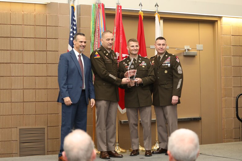 Lt. Col. Adrian Biggerstaff (second from the right), Honolulu District Commander, receives an award from Lieutenant General William H. Graham (second from the left), 56th Chief of Engineers and Commanding General, U.S. Army Corps of Engineers and Command Sergeant Major Douglas Galick (far right), 15th Command Sergeant Major, and Mr. Denver Heath, Director of Contracting, U.S. Army Corps of Engineers (left) during a contracting and small business partnerships awards ceremony on Nov. 20 at the Ernest N. Morial Convention center in New Orleans, Louisiana.