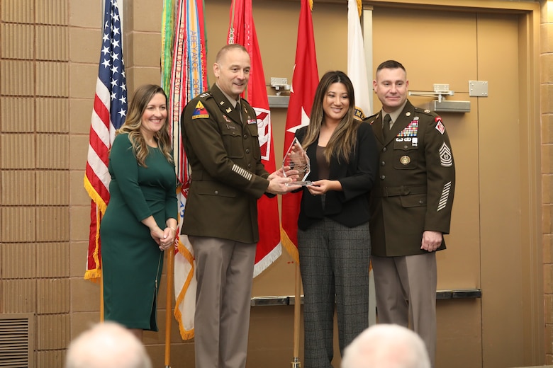 Tristin Suetsugu (second from right), Honolulu District Chief of Contracting, receives an award from Lieutenant General William H. Graham (second from the left), 56th Chief of Engineers and Commanding General, U.S. Army Corps of Engineers and Command Sergeant Major Douglas Galick (right), 15th Command Sergeant Major, and Elizabeth “Liz” Walker, Director of Small Business, U.S. Army Corps of Engineers (left) during a contracting and small business partnerships awards ceremony on Nov. 20 at the Ernest N. Morial Convention center in New Orleans, Louisiana.