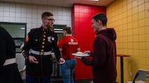 U.S. Marine Corps Sgt. Gregory Young, a production recruiter with Recruiting Station Milwaukee, passes out cake to poolees during the monthly pool function at Dubuque, Iowa, November 16, 2024. RSS Dubuque’s pool function consisted of conducting an oath of enlistment ceremony, recognizing the newest members of the delayed-entry-program, and a traditional Marine Corps cake cutting ceremony. (U.S. Marine Corps photo by Sgt. Collette Hagen)