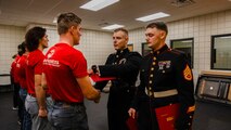 U.S. Marine Corps Capt. Jordan Olesen, an operations officer with Recruiting Station Milwaukee, congratulates the newest members of the delayed-entry-program during the monthly pool function at Dubuque, Iowa, November 16, 2024. RSS Dubuque’s pool function consisted of conducting an oath of enlistment ceremony, recognizing the newest members of the DEP, and a traditional Marine Corps cake cutting ceremony. (U.S. Marine Corps photo by Sgt. Collette Hagen)