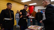 U.S. Marine Corps Staff Sgt. Chandler Swieckowski, a production recruiter with Recruiting Station Milwaukee, takes the first bite of the cake during the monthly pool function at Dubuque, Iowa, November 16, 2024. RSS Dubuque’s pool function consisted of conducting an oath of enlistment ceremony, recognizing the newest members of the delayed-entry-program, and a traditional Marine Corps cake cutting ceremony. (U.S. Marine Corps photo by Sgt. Collette Hagen)