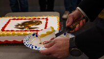 U.S. Marine Corps Capt. Jordan Olesen, an operations officer with Recruiting Station Milwaukee, cuts the first slice of cake during the monthly pool function at Dubuque, Iowa, November 16, 2024. RSS Dubuque’s pool function consisted of conducting an oath of enlistment ceremony, recognizing the newest members of the delayed-entry-program, and a traditional Marine Corps cake cutting ceremony. (U.S. Marine Corps photo by Sgt. Collette Hagen)
