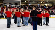 U.S. Marine Corps Capt. Jordan Olesen, an operations officer with Recruiting Station Milwaukee, delivers the oath of enlistment to the poolees of Recruiting Sub-Station Dubuque during a Dubuque Fighting Saints hockey game at Dubuque, Iowa, November 16, 2024. RSS Dubuque’s pool function consisted of conducting an oath of enlistment ceremony, recognizing the newest members of the delayed-entry-program, and a traditional Marine Corps cake cutting ceremony. (U.S. Marine Corps photo by Sgt. Collette Hagen)