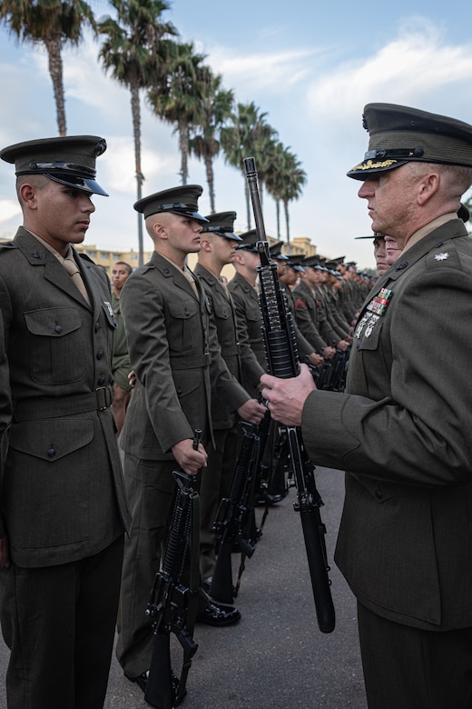 U.S. Marine Corps Lt. Col. Matthew Phelps, the commanding officer of 3rd Recruit Training Battalion, inspects a Pfc. Sayeed Montazeri with India Company, 3rd Recruit Training Battalion, during a Battalion Commander Inspection at Marine Corps Recruit Depot San Diego, California, Oct. 23, 2024. The Battalion commander’s inspection surveys new Marines’ knowledge, bearing, and attention to detail as one of their last tests before graduating. (U.S. Marine Corps photo by Lance Cpl. Jacob B. Hutchinson)