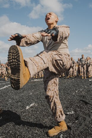 A U.S. Marine Corps recruit with Lima Company, 3rd Recruit Training Battalion, conducts dynamic warm-ups before a Marine Corps Martial Arts Program class at Marine Corps Recruit Depot San Diego, California, Oct. 29, 2024. MCMAP aims to strengthen the mental and moral resiliency of recruits and Marines through realistic combative training, warrior ethos studies, and physical hardening. (U.S. Marine Corps photo by Cpl. Sarah M. Grawcock)