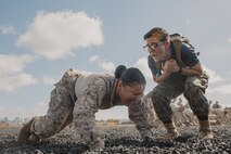 U.S. Marine Corps Sgt. Madison Polsinelli, a drill instructor with Lima Company, 3rd Recruit Training Battalion, instructs a recruit during dynamic warm-ups before a Marine Corps Martial Arts Program class at Marine Corps Recruit Depot San Diego, California, Oct. 29, 2024. MCMAP aims to strengthen the mental and moral resiliency of recruits and Marines through realistic combative training, warrior ethos studies, and physical hardening. (U.S. Marine Corps photo by Cpl. Sarah M. Grawcock)