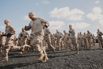 U.S. Marine Corps recruits with Lima Company, 3rd Recruit Training Battalion, run to conduct dynamic warm-ups before a Marine Corps Martial Arts Program class at Marine Corps Recruit Depot San Diego, California, Oct. 29, 2024. MCMAP aims to strengthen the mental and moral resiliency of recruits and Marines through realistic combative training, warrior ethos studies, and physical hardening. (U.S. Marine Corps photo by Cpl. Sarah M. Grawcock)