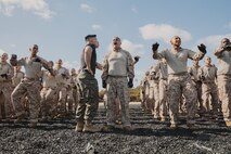 U.S. Marine Corps Martial Arts Instructor, Staff Sgt. Patrick Chok, with Support Battalion, Recruit Training Regiment, instructs a recruit with Lima Company, 3rd Recruit Training Battalion, on how to properly conduct dynamic warm-ups before a Marine Corps Martial Arts Program class at Marine Corps Recruit Depot San Diego, California, Oct. 29, 2024. MCMAP aims to strengthen the mental and moral resiliency of recruits and Marines through realistic combative training, warrior ethos studies, and physical hardening. (U.S. Marine Corps photo by Cpl. Sarah M. Grawcock)