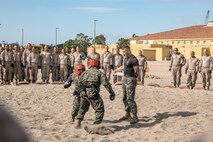 U.S. Marine Corps Martial Arts Instructor, Staff Sgt. Jacob Sinclair, with Support Battalion, Recruit Training Regiment, gives recruits with Fox Company, 2nd Recruit Training Battalion, a demonstration before a body sparring event at Marine Corps Recruit Depot San Diego, California, Oct. 28, 2024. Recruits are taught Marine Corps Martial Arts Program techniques that instill basic self-defense that they will execute throughout recruit training during events like body sparring and pugil sticks to help build a warrior ethos and esprit de corps. (U.S. Marine Corps photo by Cpl. Sarah M. Grawcock)