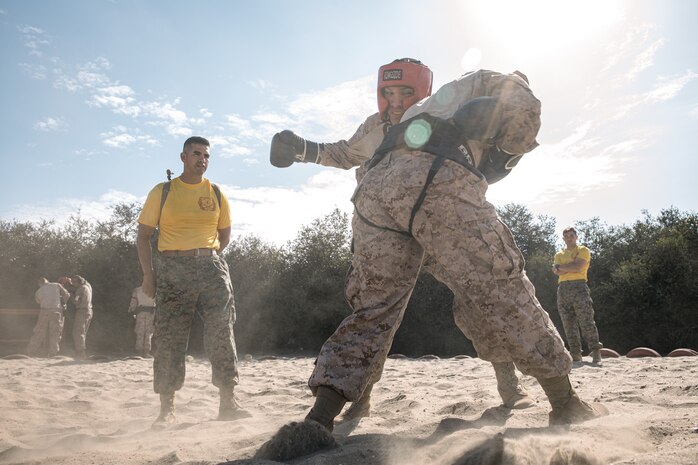 U.S. Marine Corps Staff Sgt. Deltoro, left, a drill instructor with Fox Company, 2nd Recruit Training Battalion, observes a body sparring event at Marine Corps Recruit Depot San Diego, California, Oct. 28, 2024. Recruits are taught Marine Corps Martial Arts Program techniques that instill basic self-defense that they will execute throughout recruit training during events like body sparring and pugil sticks to help build a warrior ethos and esprit de corps. (U.S. Marine Corps photo by Cpl. Sarah M. Grawcock)