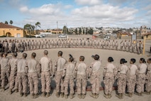 U.S. Marine Corps recruits with Fox Company, 2nd Recruit Training Battalion, wait for instructions before a body sparring event at Marine Corps Recruit Depot San Diego, California, Oct. 28, 2024. Recruits are taught Marine Corps Martial Arts Program techniques that instill basic self-defense that they will execute throughout recruit training during events like body sparring and pugil sticks to help build a warrior ethos and esprit de corps. (U.S. Marine Corps photo by Cpl. Sarah M. Grawcock)