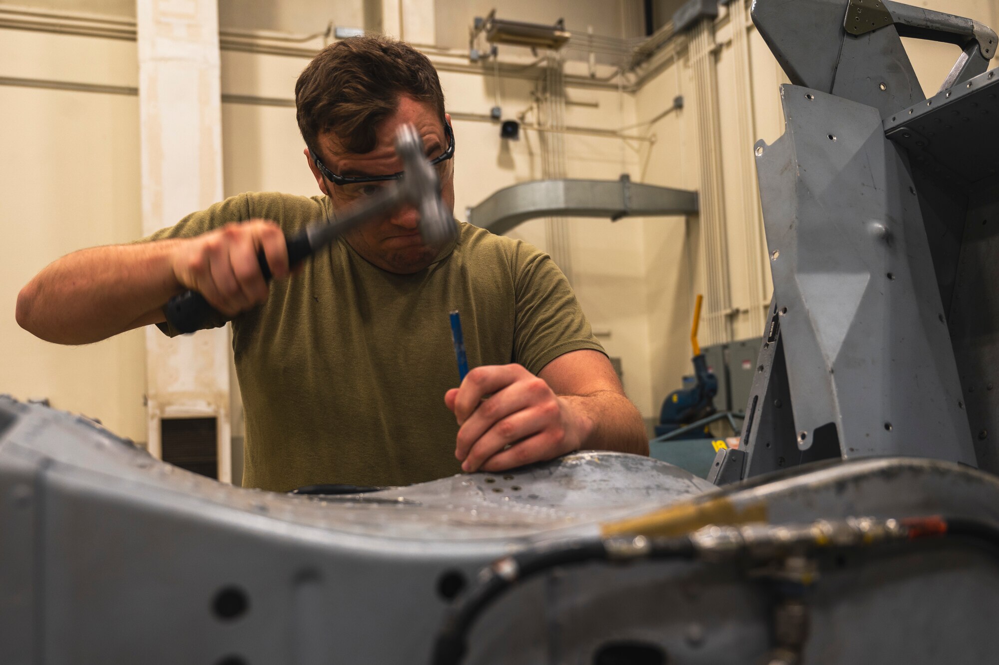 U.S. Air Force Staff Sgt. Nathan Frank, 8th Maintenance Squadron aircraft structural maintenance technician, replaces rivets on an F-16 Fighting Falcon test seat.