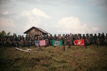 U.S. Marines with 2nd Battalion, 7th Marine Regiment, attached to Marine Rotational Force-Southeast Asia, alongside Indonesian marines with 10th Marine Infantry Battalion, Indonesian Korps Marinir, pose for a photo after conducting a coastal defense exercise during Keris Marine Exercise (MAREX) 2024 on Kabupaten Lingga, Singkep, Indonesia, Nov. 15, 2024.