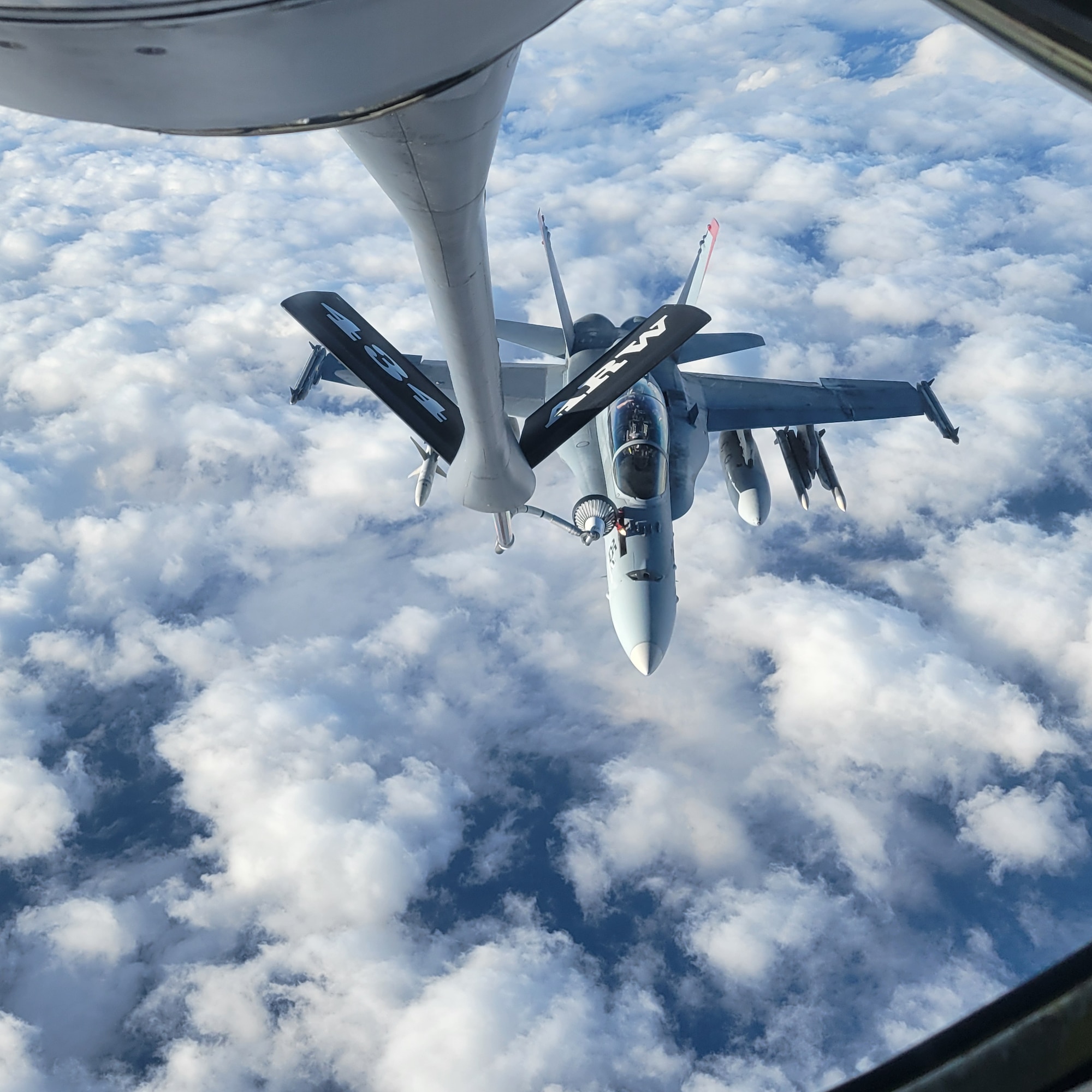 A military aircraft receives fuel during flight.