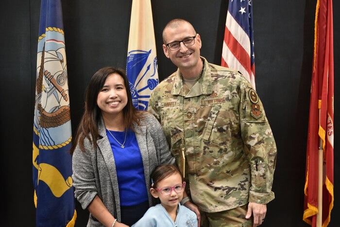 U.S. Air Force Chief Master Sgt. Select Brandon Abbott and his family stand for a photo after the Chief Release Party at the Powell Event Center, Goodfellow Air Force Base, Texas, Nov. 18, 2024. Abbott was one of 503 personnel selected for promotion to chief master sergeant in the 2024 promotion cycle. (U.S. Air Force photo by 1st Lt. Harris Hillstead)