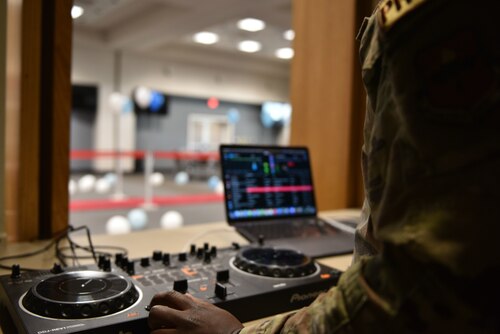 U.S. Air Force Senior Airman David Chima, 17th Comptroller Squadron commander support staff, prepares audio equipment before the Chief Release Party at the Powell Event Center, Goodfellow Air Force Base, Texas, Nov. 18, 2024. Chima acted as the DJ for the event. (U.S. Air Force photo by 1st Lt. Harris Hillstead)