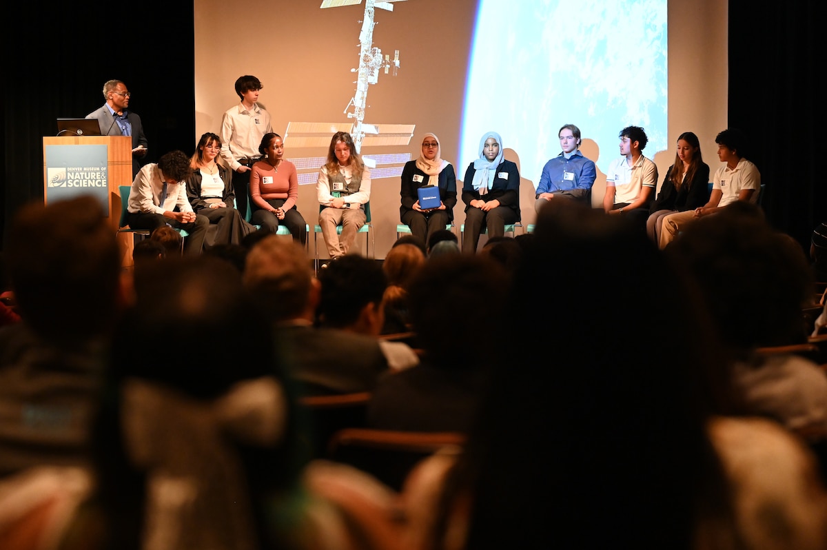 Student answers questions on stage