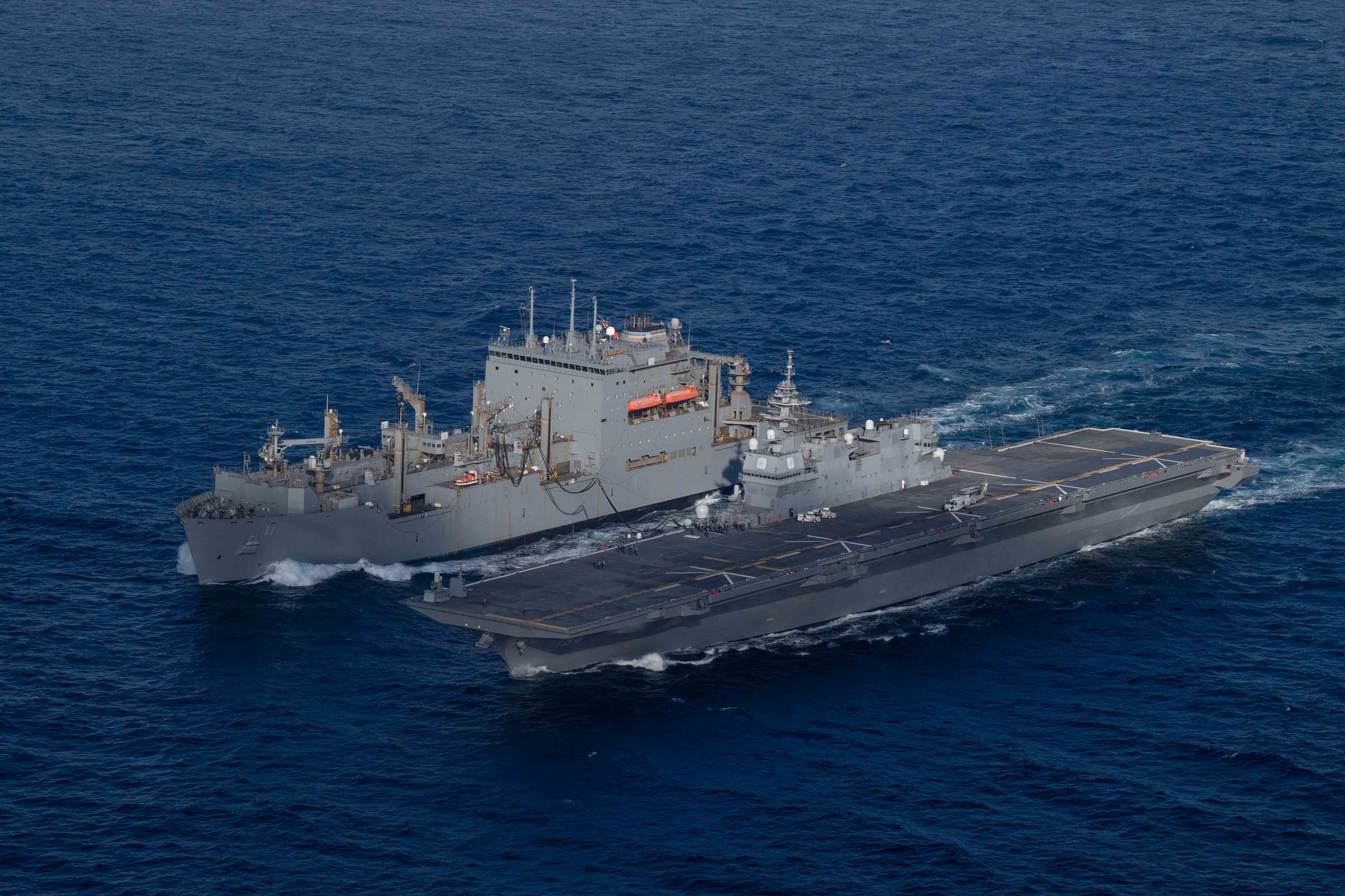 The U.S. Navy Lewis and Clark-class dry cargo ship USNS Washington Chambers (T-AKE-11), left, conducts a replenishment-at-sea with the Japan Maritime Self-Defense Force Izumo-class multi-functional destroyer JS Kaga (DDH 184) while underway in the Pacific Ocean, Nov. 18, 2024.