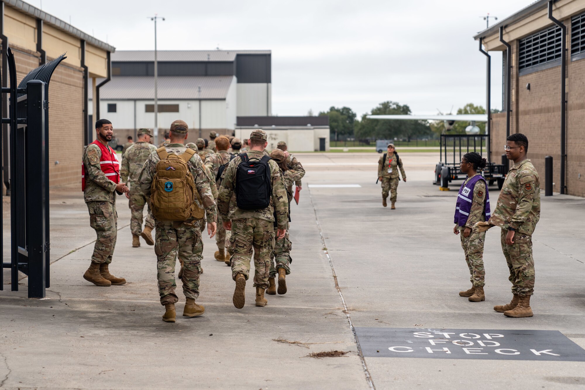 Airmen assigned to the 81st Training Wing prepare to board a bus to simulate departing for a deployment during the Combat Readiness Inspection at Keesler Air Force Base, Mississippi, Nov. 19, 2024.