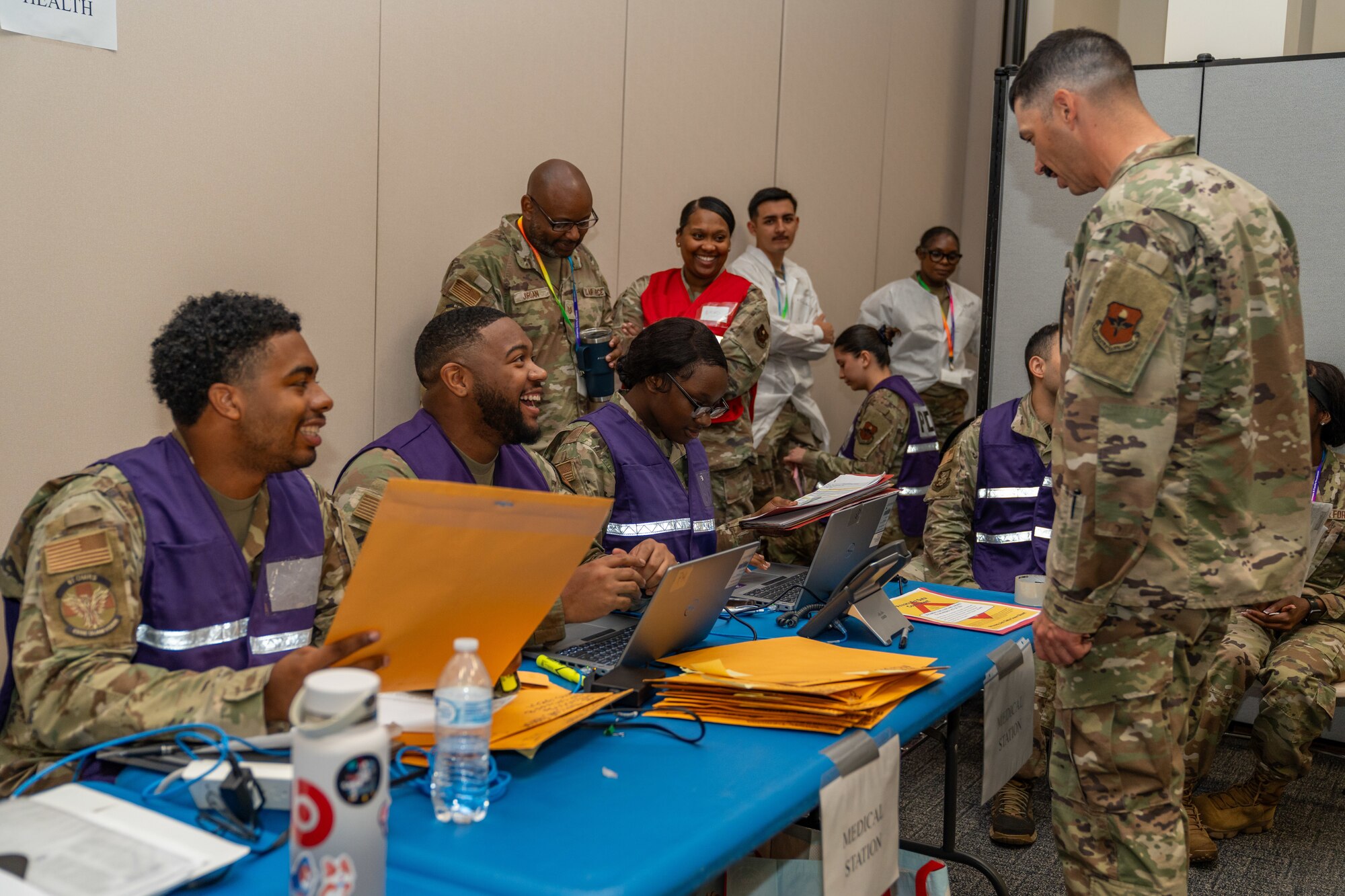 U.S. Air Force Maj. Christopher Foote, 81st Medical Support Squadron military information systems flight commander, right, checks in at the medical station of a deployment line during the Combat Readiness Inspection at Keesler Air Force Base, Mississippi, Nov. 19, 2024.